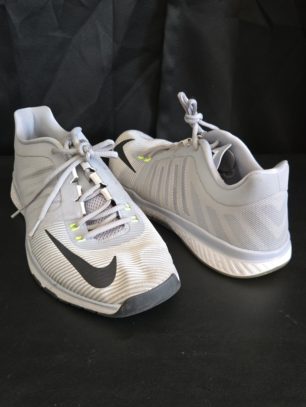 Nike Zoom Light Gray Athletic Shoes with Black Swoosh and Neon Yellow Accents
